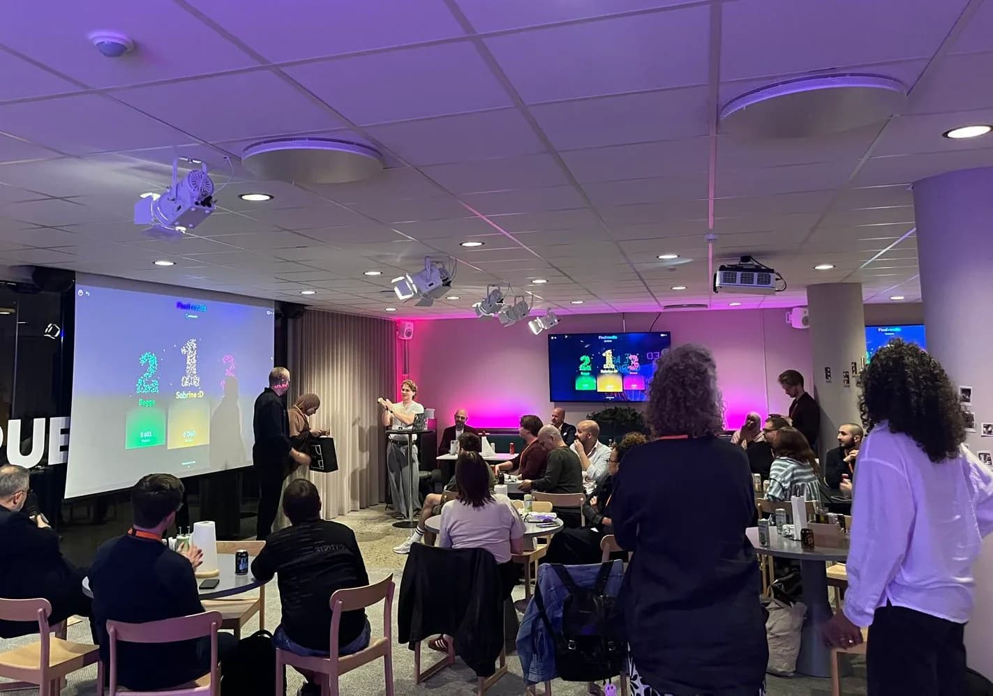 People watching a SkillTap scoreboard at a community event
